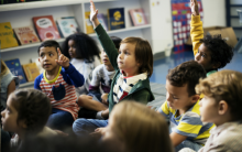 preschool children raising hands in class