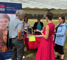 Adults talking at a picnic