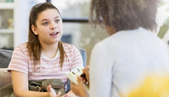 teenage girl speaking to carer