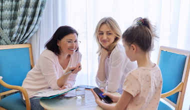Two adults meeting with a child